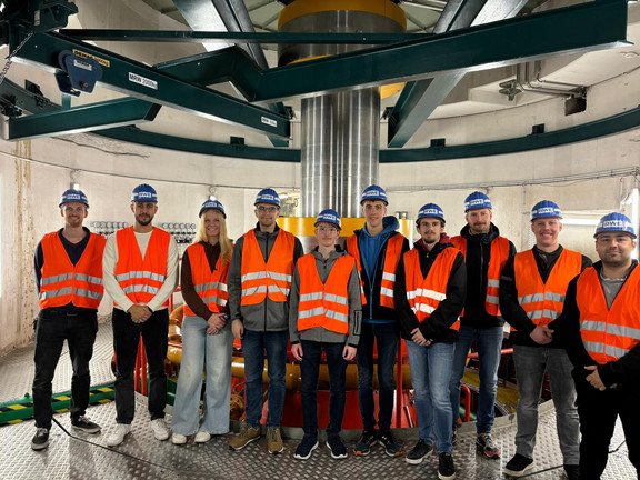 Students in front of the drive shaft between pump turbine and motor generator.